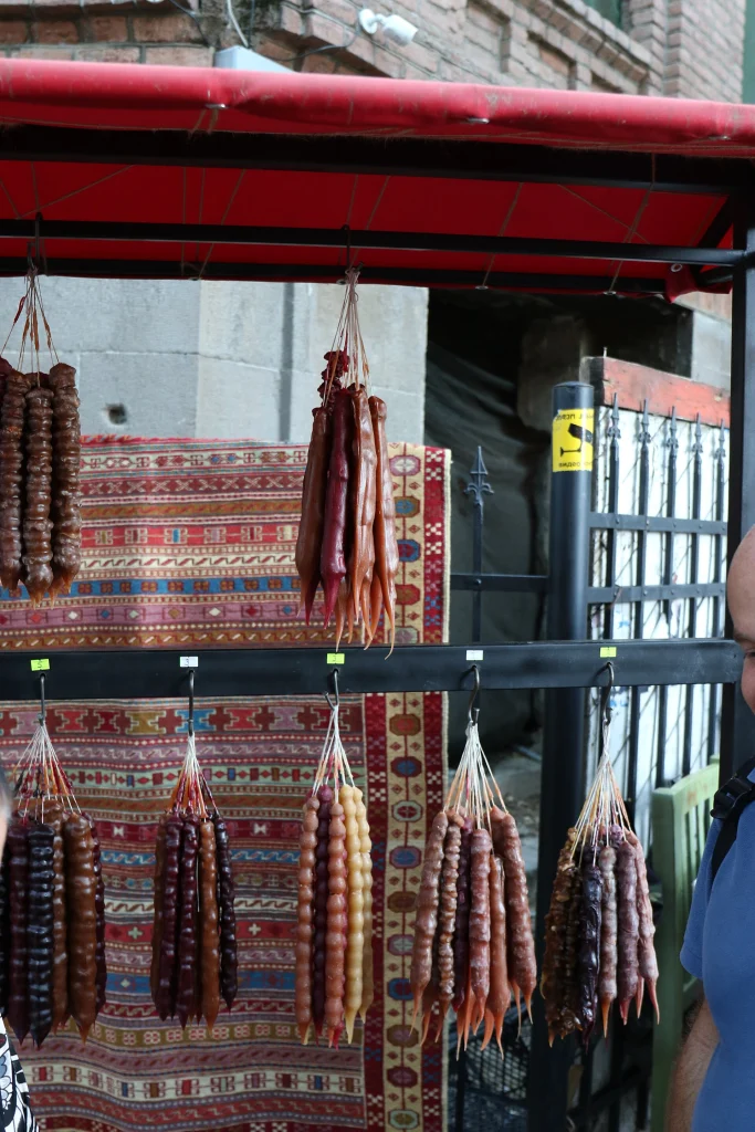 Strings of churchkhela hanging for sale at a street market in Georgia.