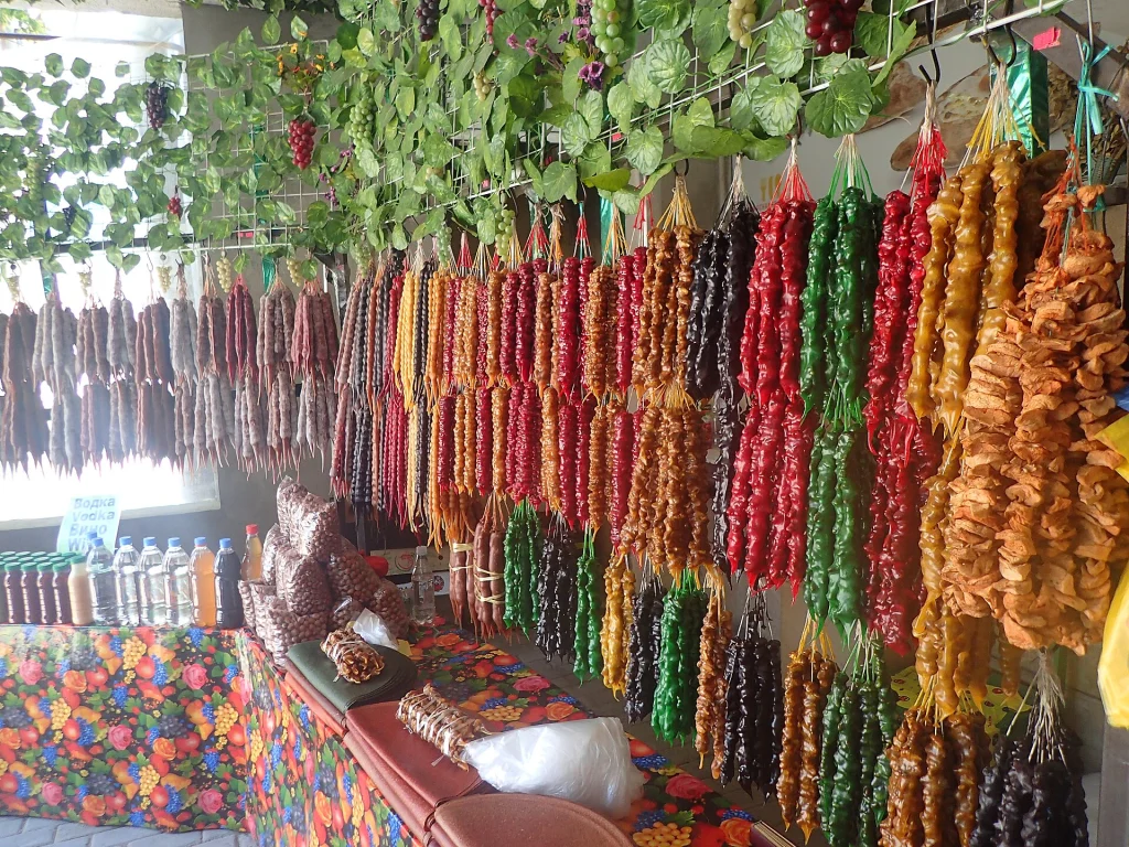 Colorful rows of churchkhela and dried fruit displayed at a Georgian market stall.