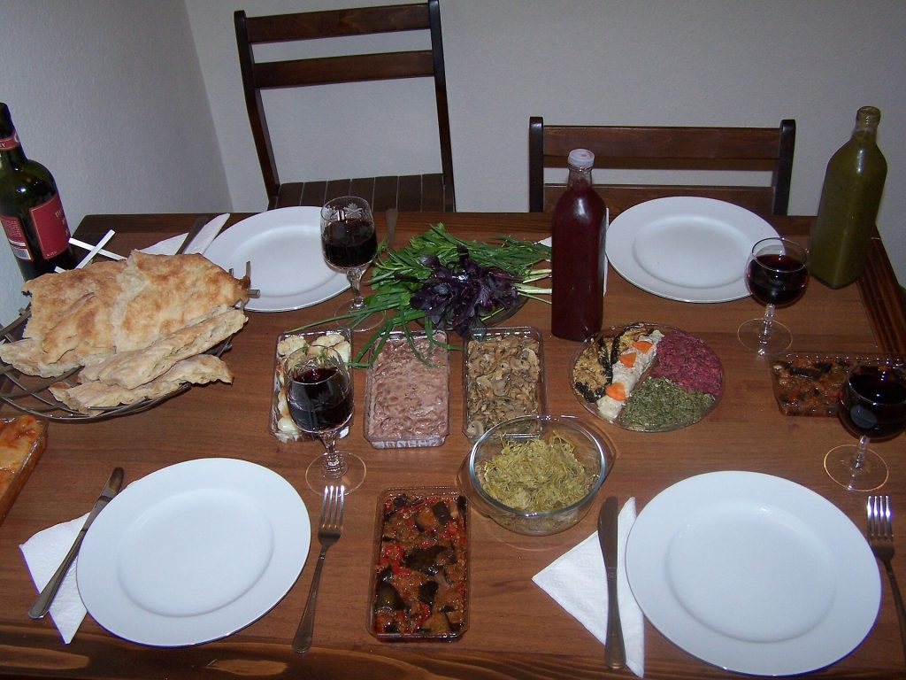 Guests gather around a bountiful Georgian supra, a central feature of the Ghvtaeboba feast.
