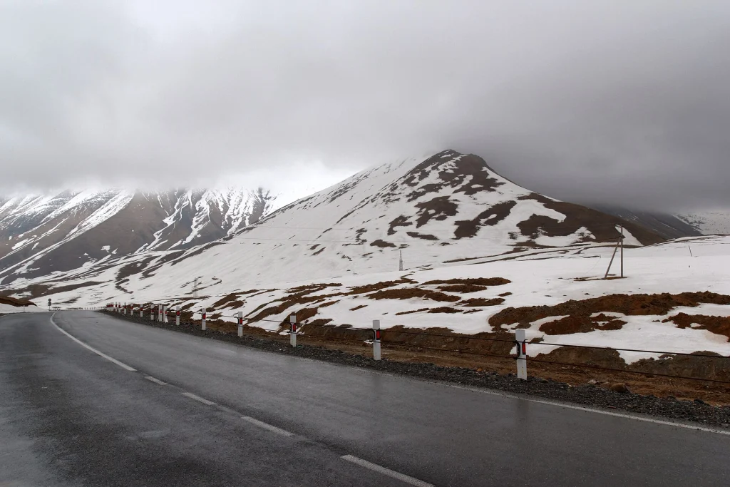 Snow still lingers beside the Georgian Military Road near Krestovy Pass in early season.