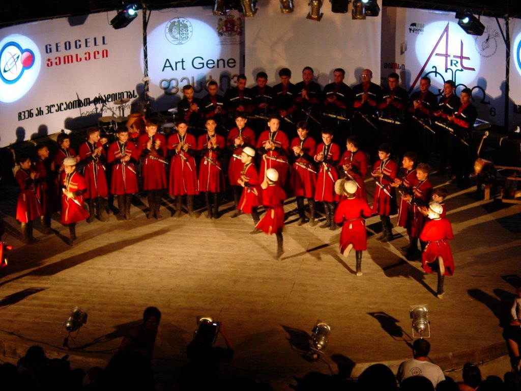 Georgian folk dancers in traditional costume perform at a cultural festival, echoing Tianetoba's celebratory spirit.
