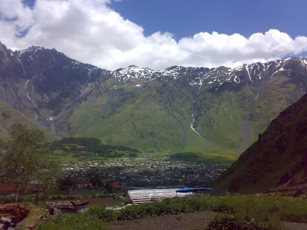 Gergeti village beneath the Caucasus mountains, a classic Georgian travel destination.