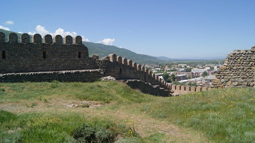 Crenellated ramparts of Gori Fortress stretch along the hilltop with the valley beyond.