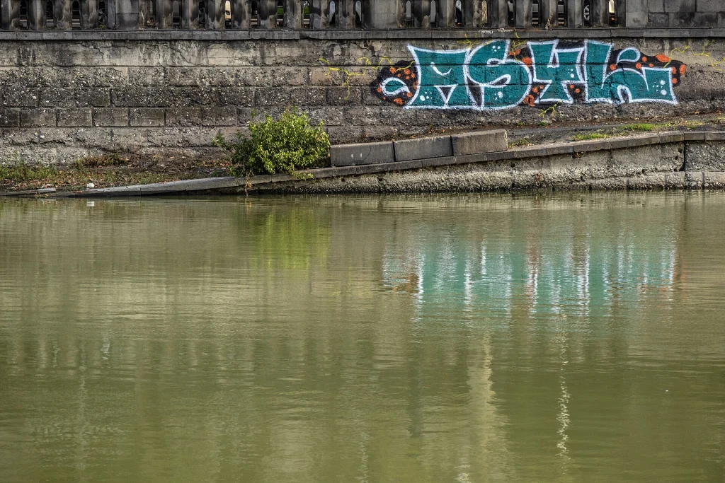 Riverside embankment with graffiti along the Kura River in Tbilisi, Georgia.