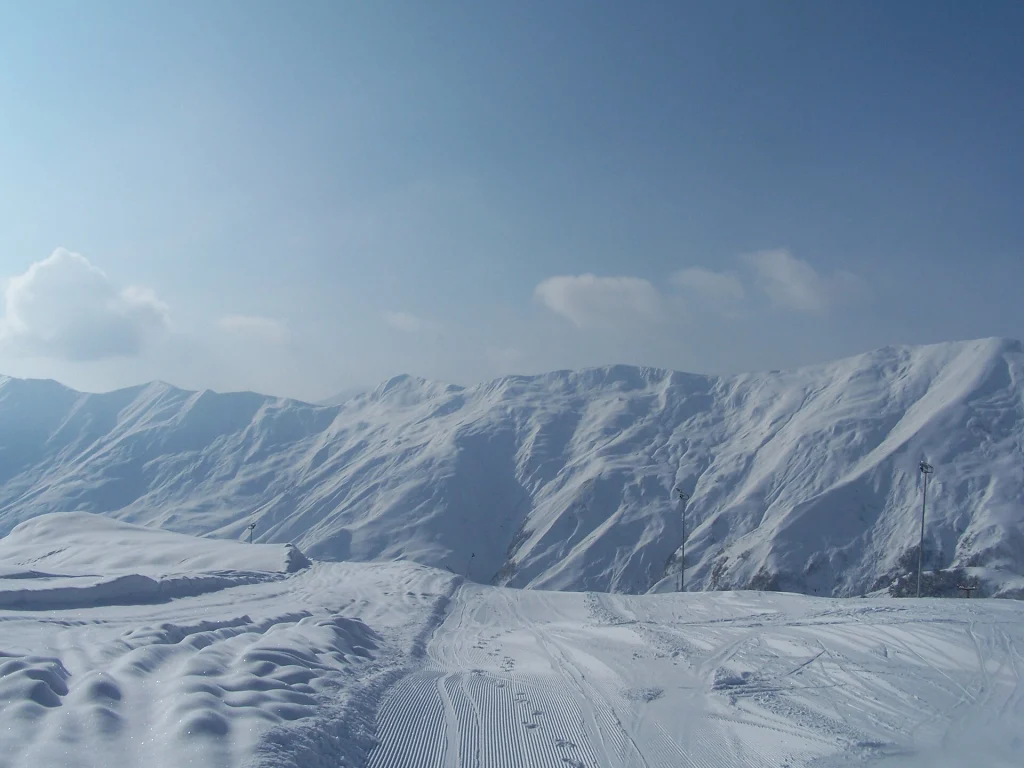 Snow-covered peaks above Gudauri, typical of Georgia's dramatic mountain landscapes popular with UK skiers.