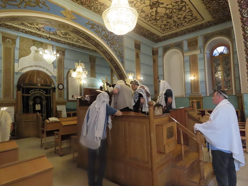 Worshippers gather for prayer inside the Great Synagogue of Tbilisi, a living hub for the local Jewish community.