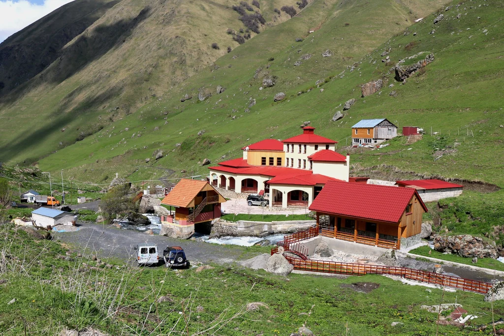 Guesthouses nestle in the green Sno Valley beneath the mountains at Juta.