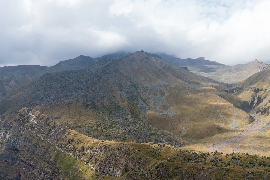 Mountain trail landscape toward Gergeti glacier in Kazbegi National Park, Georgia.