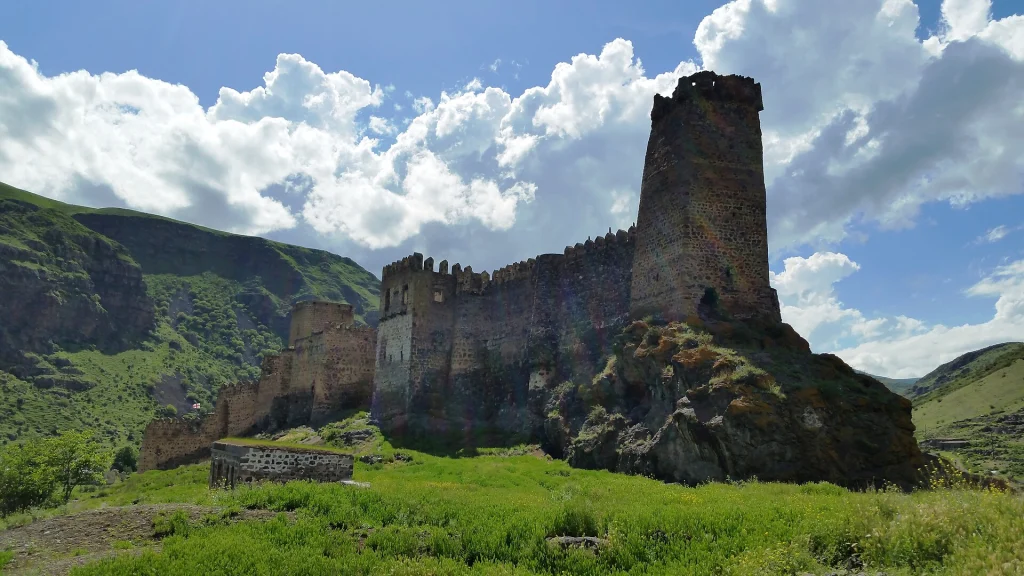 The southeastern tower and ramparts of Khertvisi Fortress rise above green hills.