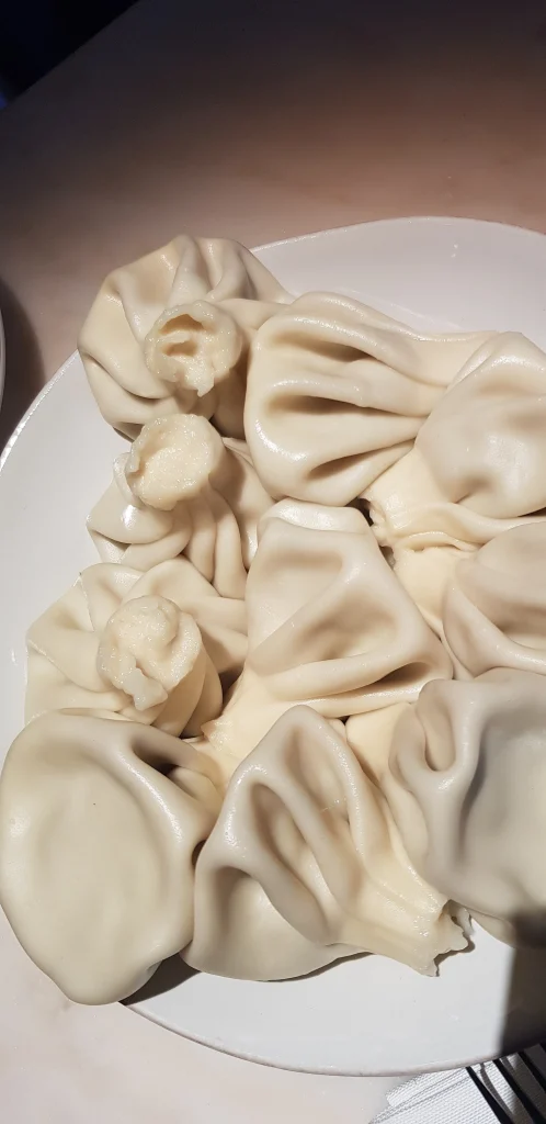 A plate of khinkali dumplings, a signature Georgian food experience for travellers.