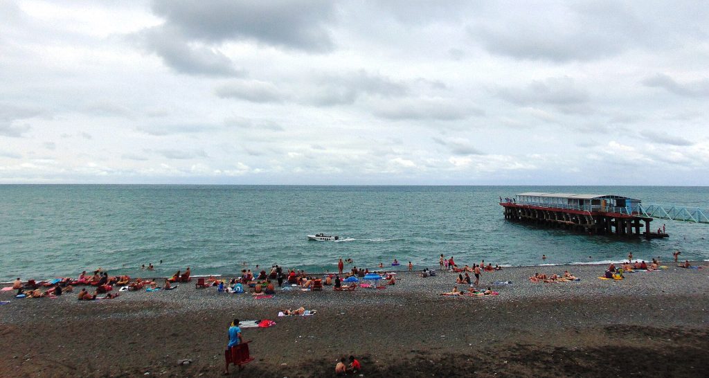 Holidaymakers fill Kobuleti beach near the pier at the height of the summer season.