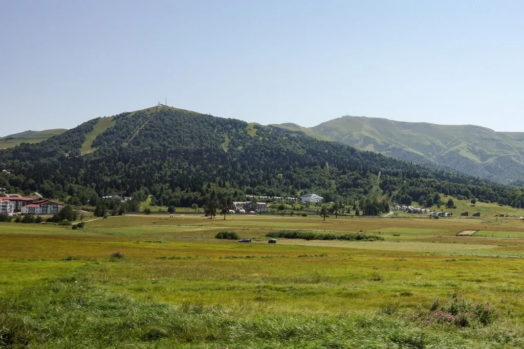 Green mountains Kokhtagora and Sakvelo rise above the valley at Bakuriani.