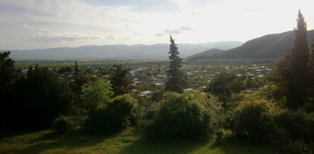 Panoramic view of Kvareli town nestled below the mountains near the lake.