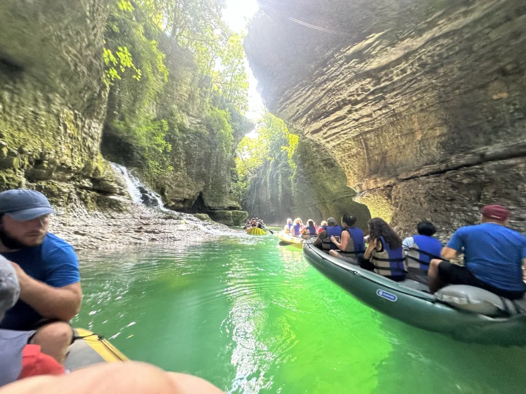 Visitors raft through the turquoise waters of Martvili Canyon, a popular Georgia excursion.