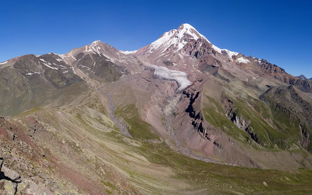 Mount Kazbek and Gergeti Glacier seen from a nearby ridge along the ascent route.