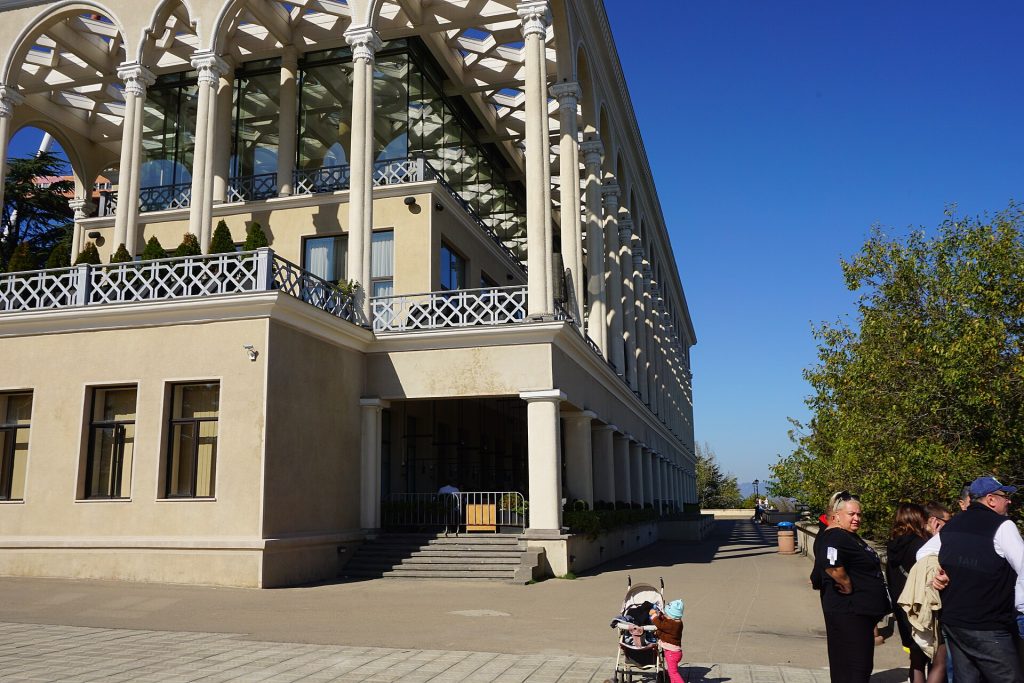 Visitors stroll past one of Mtatsminda Park's buildings, the festival's hilltop venue in Tbilisi.