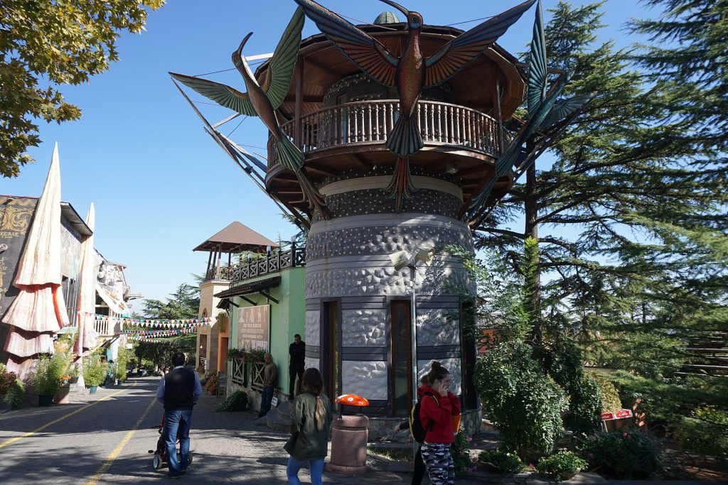 Visitors stroll past the distinctive tower building in Mtatsminda Park, the festival's venue.