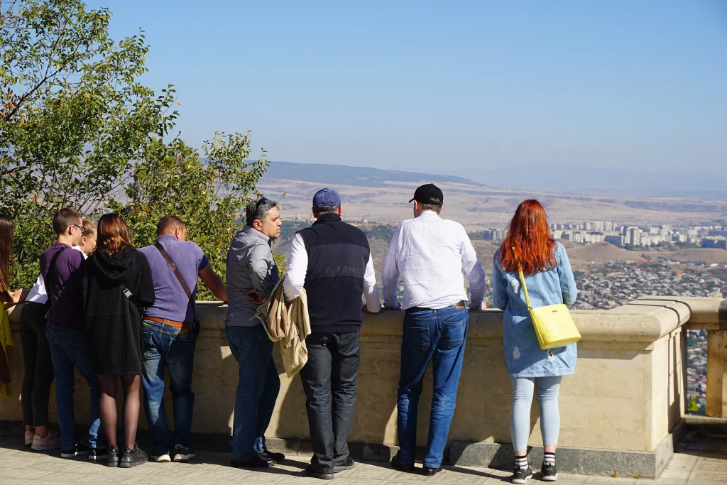 Visitors gather at the Mtatsminda viewpoint overlooking Tbilisi, a popular stop on the mountain adventure route.
