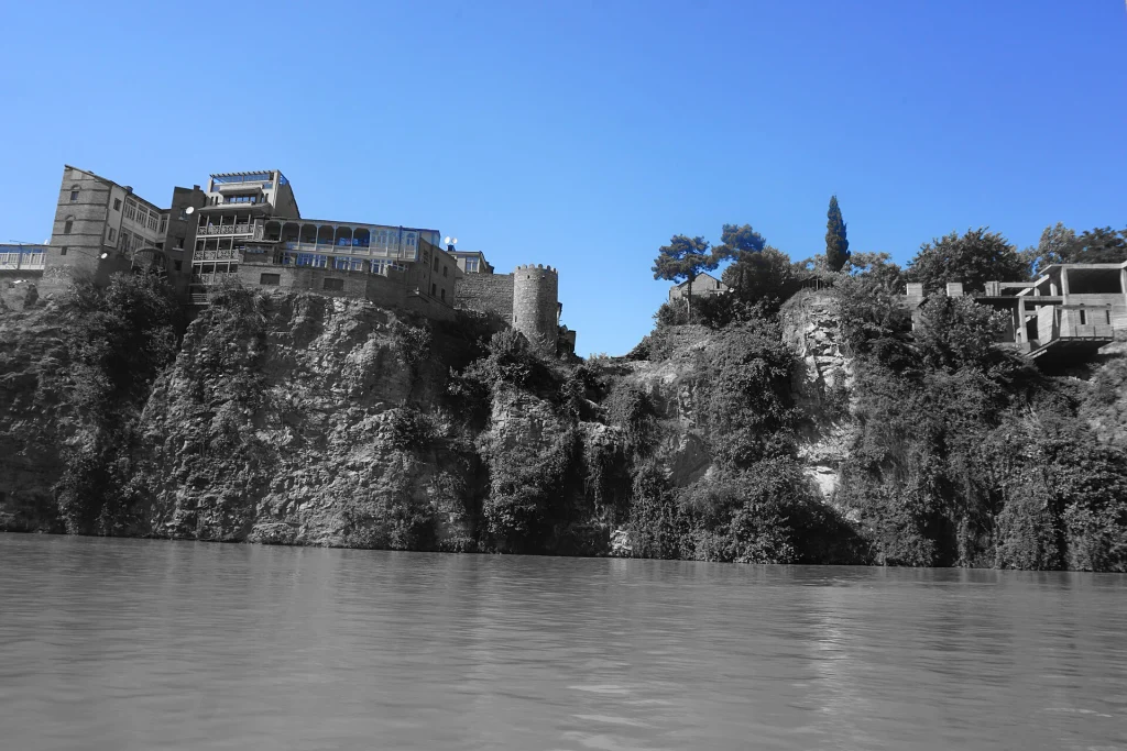View of Tbilisi's old town cliffside buildings above the Mtkvari River.