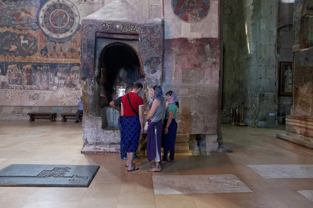 Pilgrims explore the historic interior of Svetitskhoveli Cathedral, reflecting Georgia's deep Christian heritage.