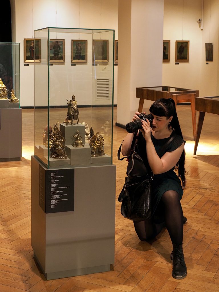 A photographer documents museum exhibits, reflecting the festival's focus on photographic practice.