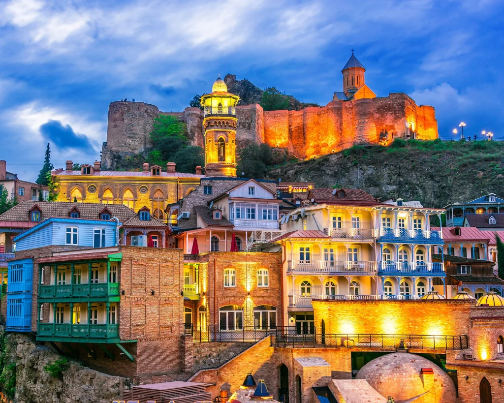 Narikala Fortress illuminated above Tbilisi's Old Town, the city's signature landmark.