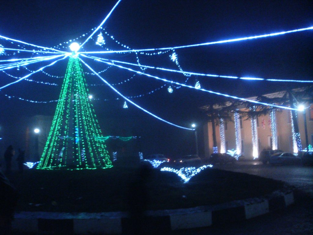 Festive lights decorate Dusheti's central square during a town celebration.