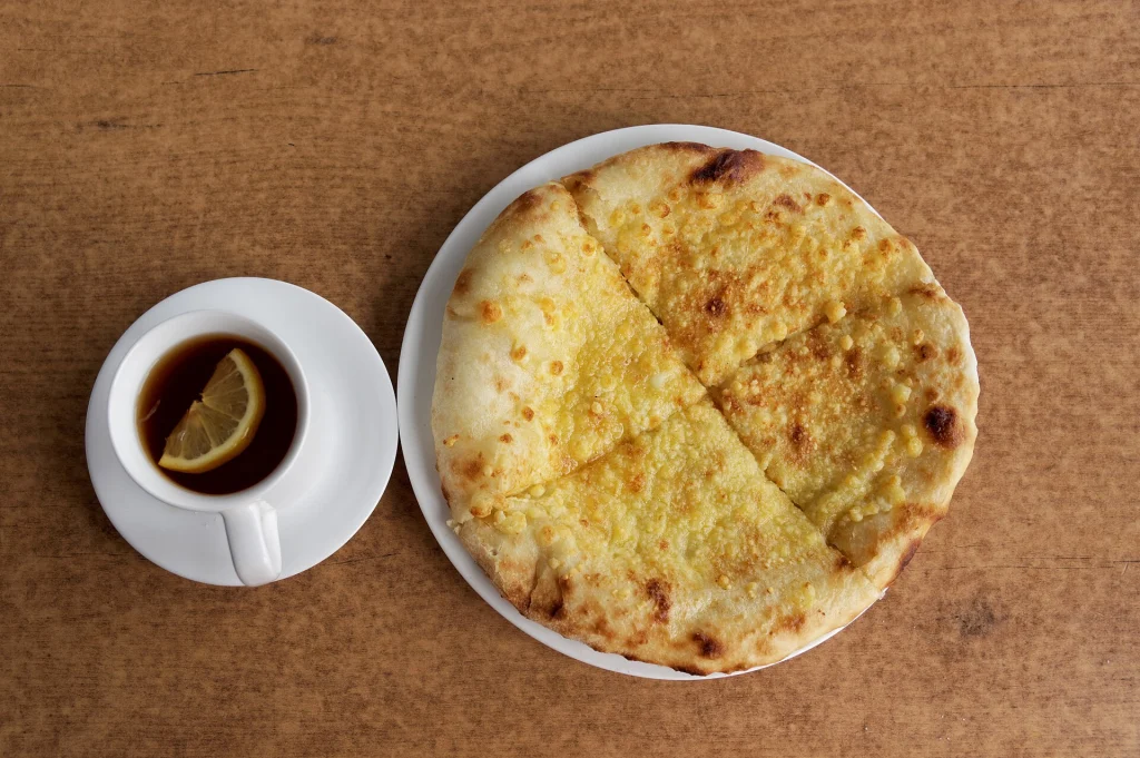 Khachapuri served with tea in Tbilisi's Old Town, a dish easily adapted for vegetarian diets.