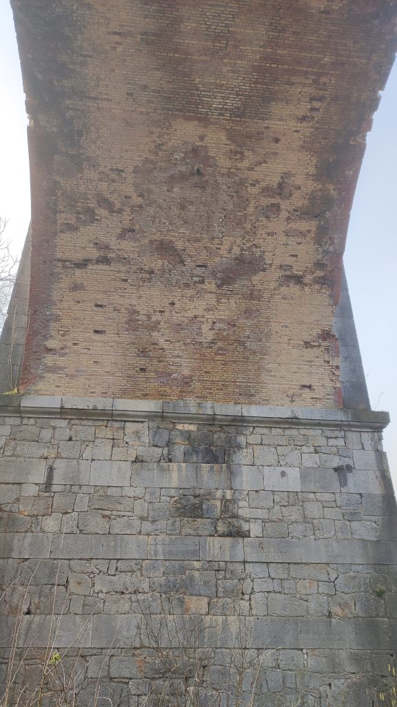 The historic Breg viaduct arch overlooking Pako village in Lentekhi, Lower Svaneti.