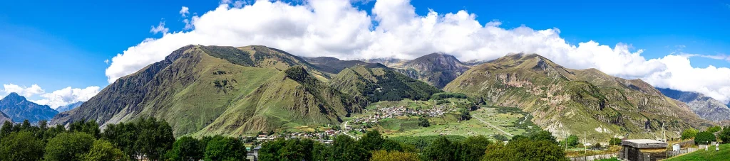 Panoramic view of Stepantsminda, the gateway village beneath Mount Kazbek.