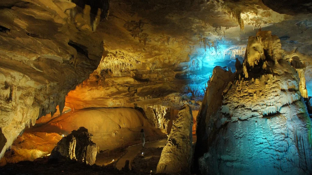Illuminated stalactites and stalagmites inside the Prometheus Cave in Imereti, Georgia.