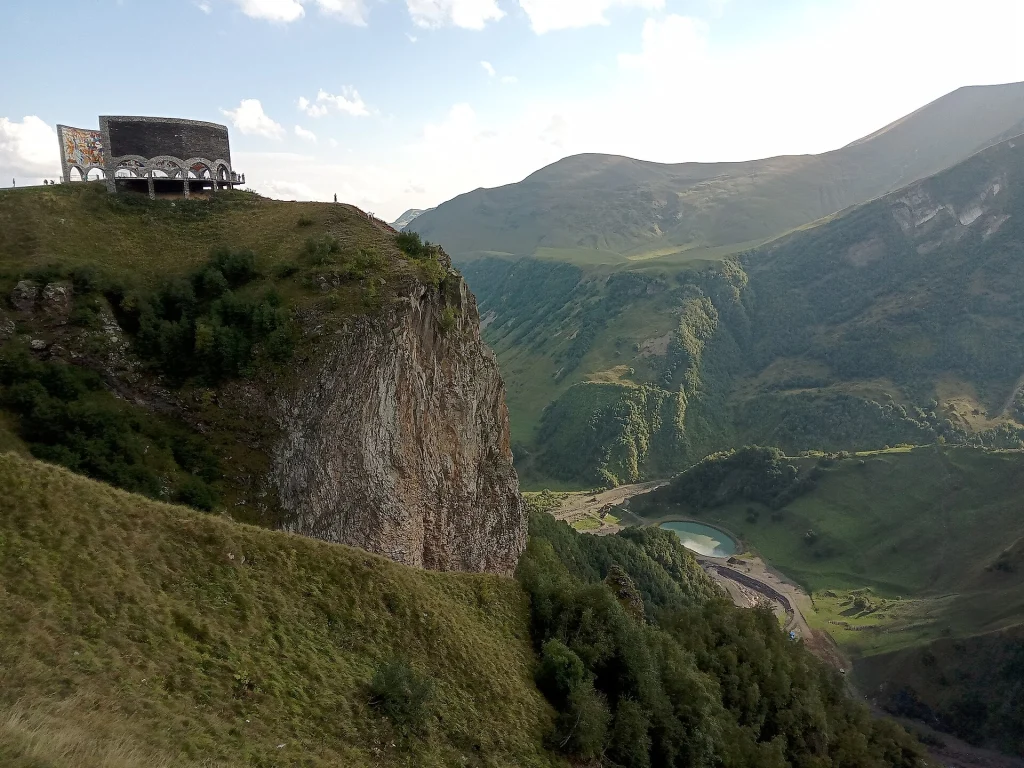 The Russia-Georgia Friendship Monument perched on a cliff above the dramatic Jvari Pass valley.