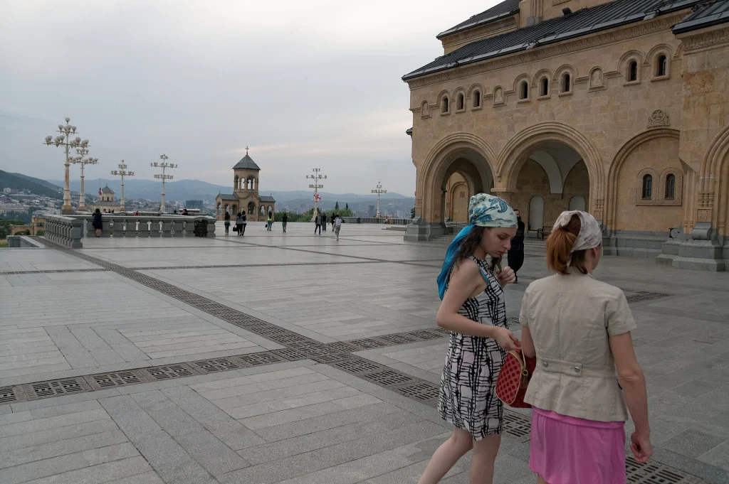 Visitors stroll the plaza outside Tbilisi's Holy Trinity Cathedral, a must-see city sight.