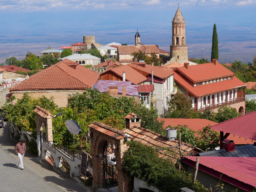 Hilltop town of Sighnaghi with red-tiled roofs, cathedral tower and the Alazani Valley beyond.