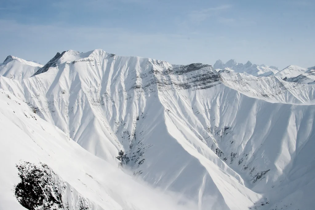 Deep snow blankets the dramatic mountain ridges around Gudauri in winter.