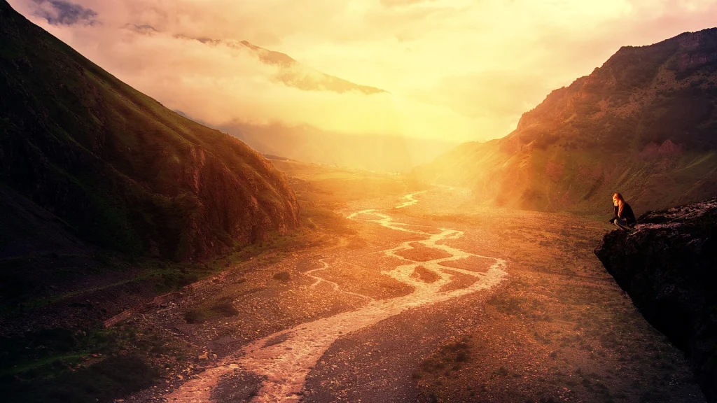 Sunset over a river valley in the Caucasus Mountains of Georgia, a popular hiking destination.