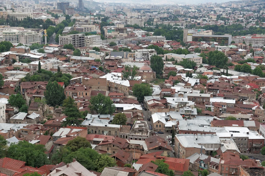 Panoramic view over Tbilisi's old town rooftops, the capital city travellers typically visit.