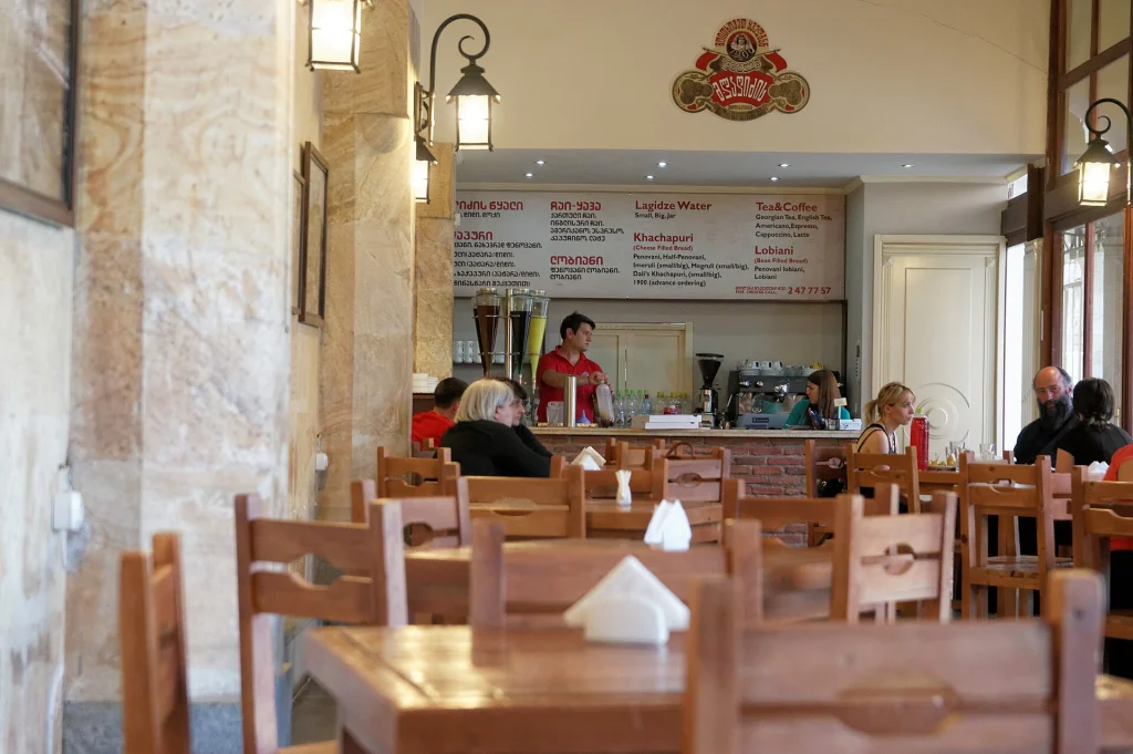 Diners seated in a Tbilisi café, illustrating typical restaurant settings in Georgia.