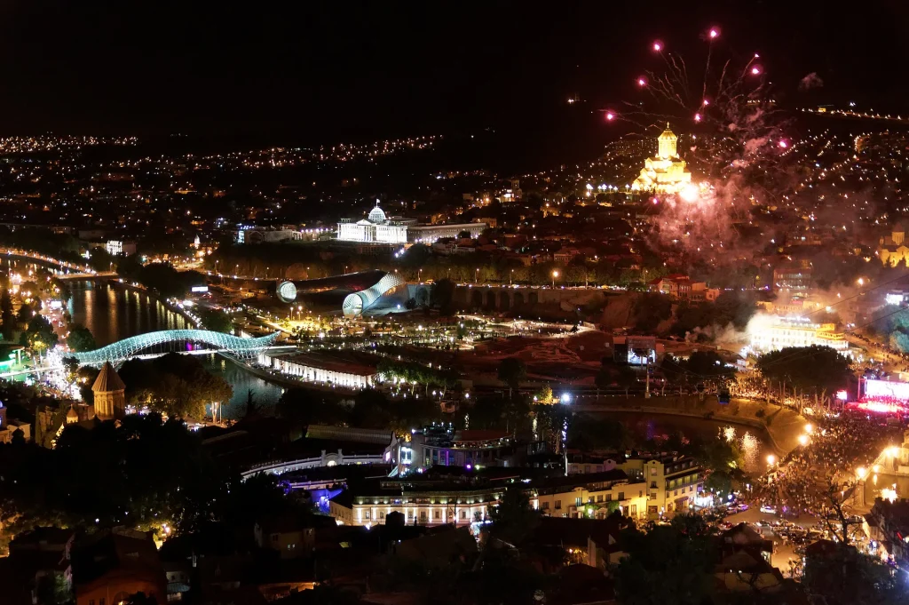 Tbilisi city centre lit up at night during a holiday, showing the capital's skyline.