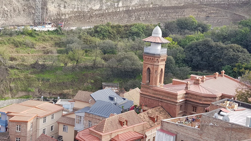 The Juma Mosque minaret, serving both Shia and Sunni Muslims including Iranian visitors.
