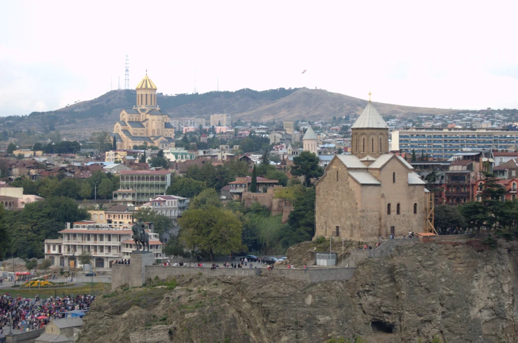 Panoramic view of Tbilisi's Old Town with its historic churches and hillside skyline.