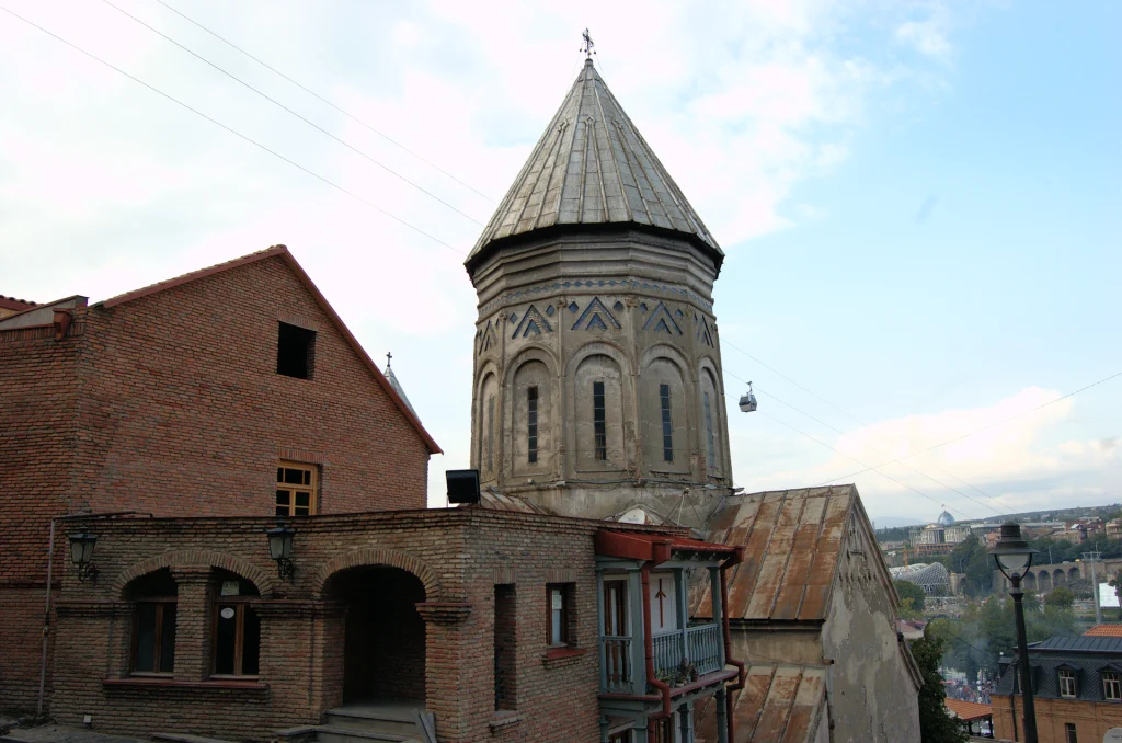 Traditional rooftops and a church tower in Tbilisi's historic Old Town district.