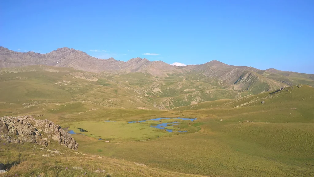 Mountain lake and high Caucasus peaks near the Georgian-Dagestan border along the trek route.