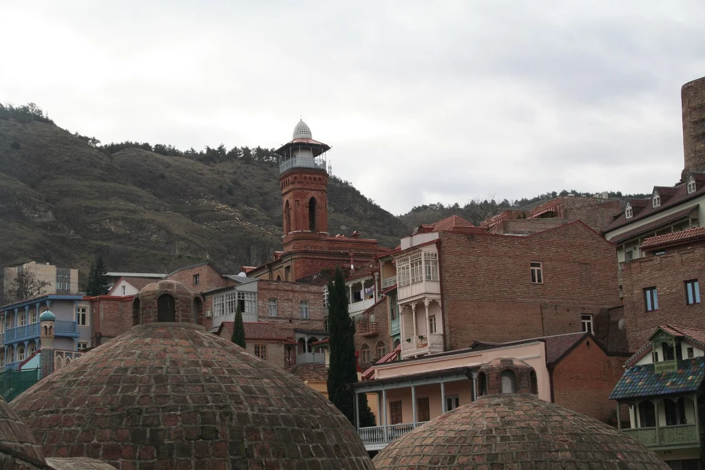 The Juma Mosque minaret rises above Tbilisi's Old Town rooftops near the sulphur baths.