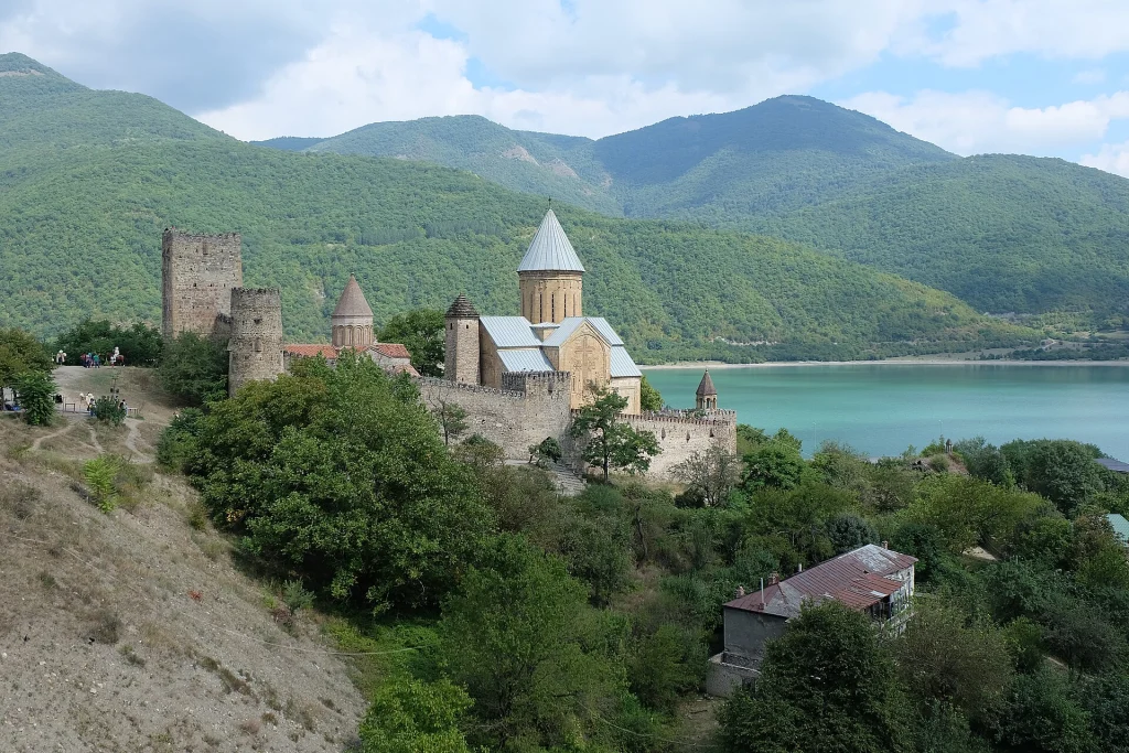 Ananuri Fortress overlooks the mountain road toward the Georgian Military Highway, a route requiring extra driving caution.