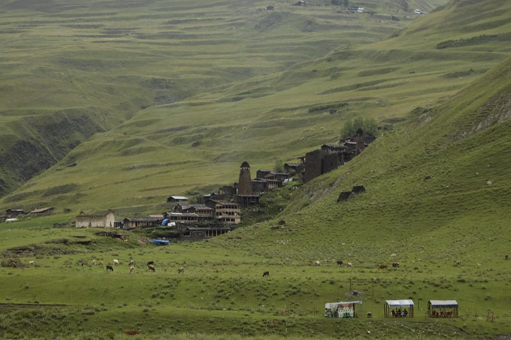 Aerial view of Dartlo village nestled in the rolling green mountains of Tusheti, Georgia.