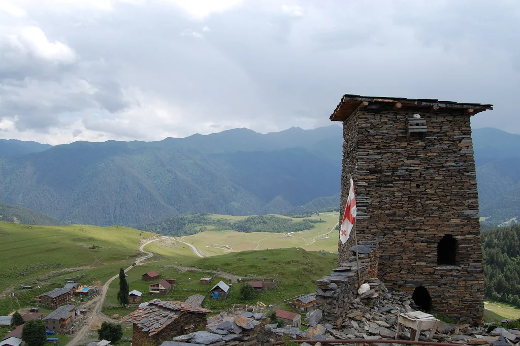 A stone defensive tower overlooks the scattered houses of Omalo village, the main gateway to Tusheti.
