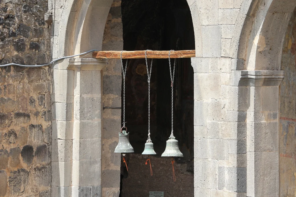 Three bells hang at the entrance to the Church of the Dormition at Vardzia.
