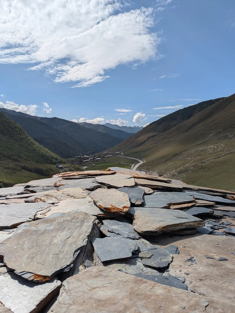Panoramic view over Ushguli's stone towers and the Enguri River valley.