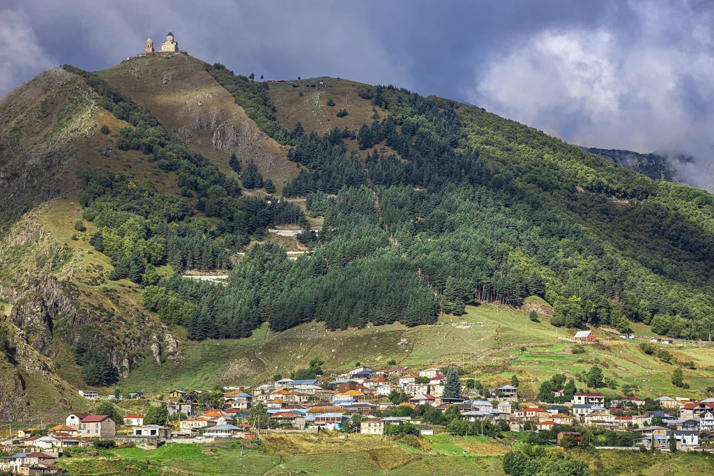 Gergeti Trinity Church crowns the ridge above Stepantsminda near Kazbegi.